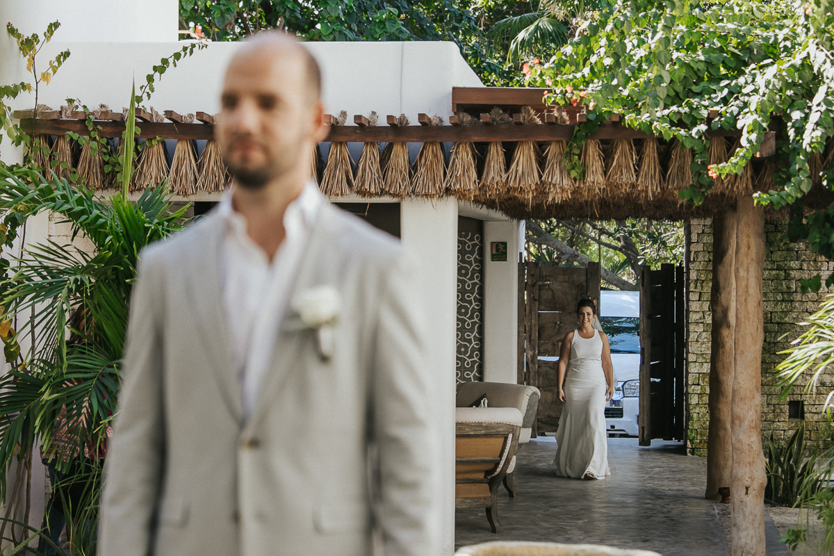 Bride and groom first look at Chiringuito Tulum Wedding in Mexico by Caro Navarro Photography