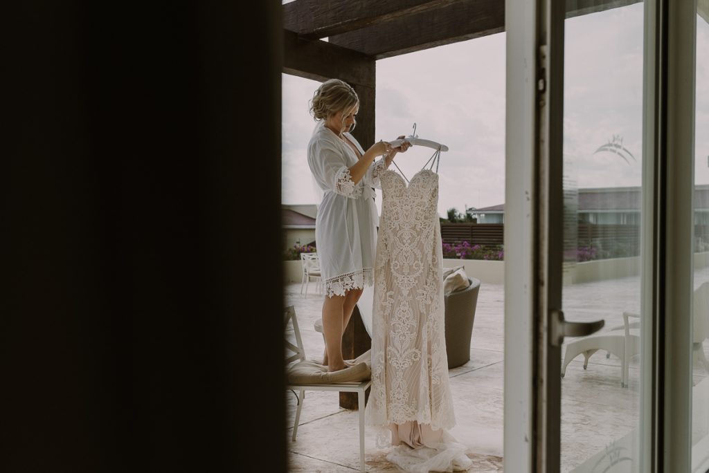 Bride getting into her dress. Caro Navarro Moon Palace Wedding Photography