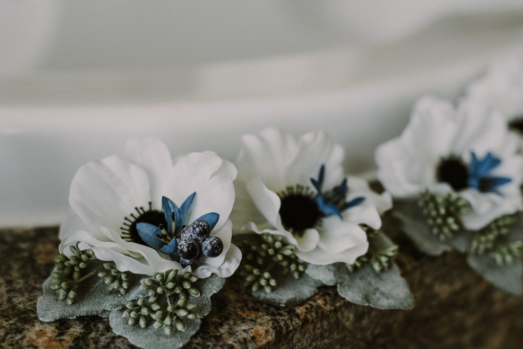 Winter wedding boutonnieres by Caro Navarro Photography at Moon Palace Nizuc Cancun