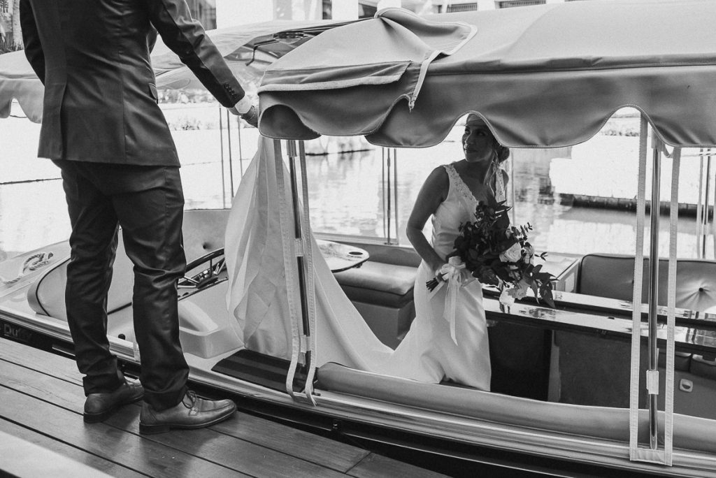 Bride on boat at Banyan Tree Mayakoba, Mexico. Caro Navarro Wedding Photography