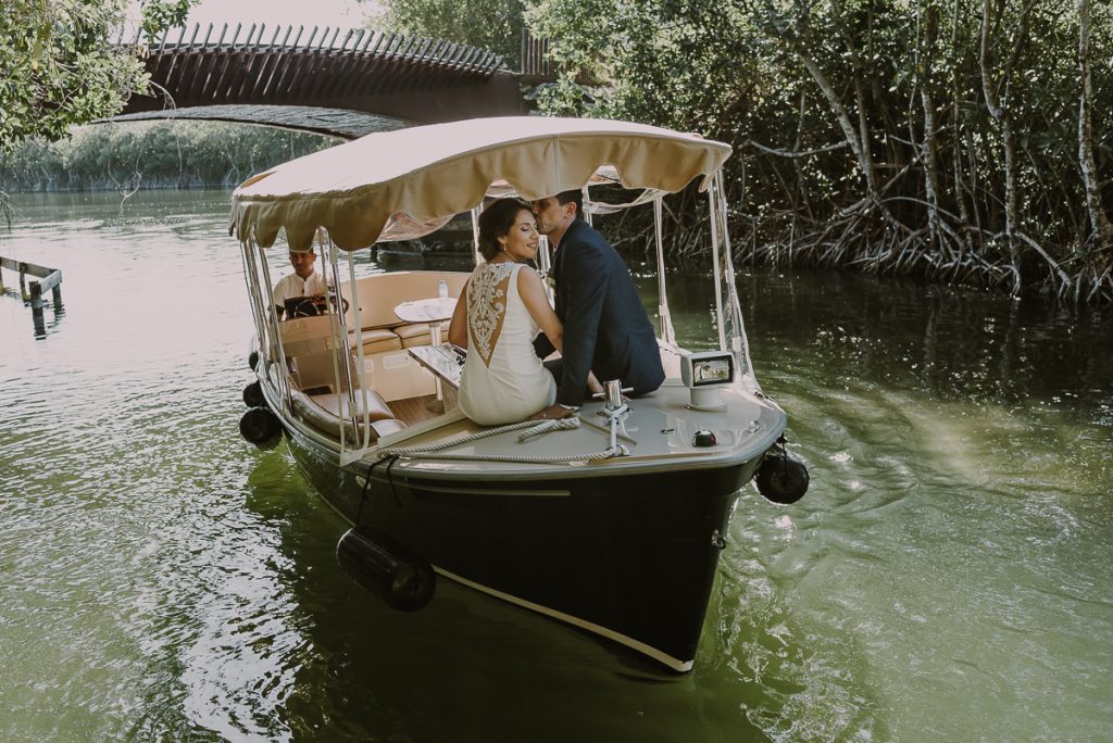 Bride and groom portraits on boat at Banyan Tree Mayakoba, Mexico. Caro Navarro Photography