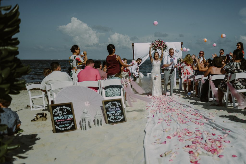 Bride and groom exit with beach balls toss. Now Sapphire Wedding by Caro Navarro Photography