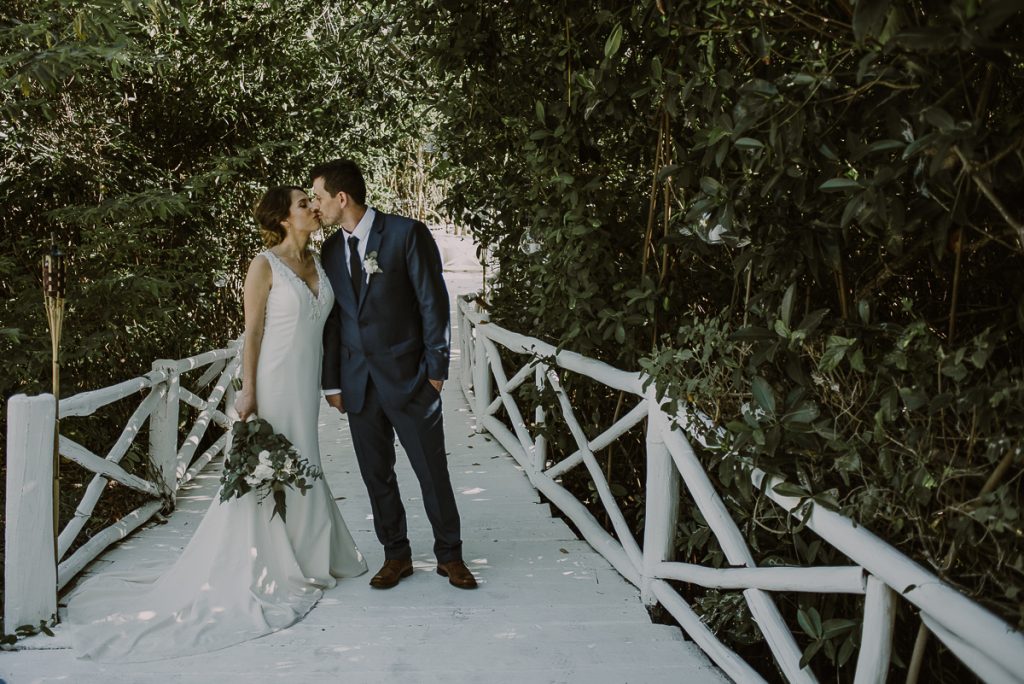 Bride and groom photos on white deck at Banyan Tree Mayakoba, Mexico. Caro Navarro Photography