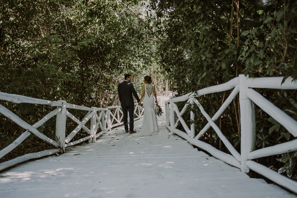 Bride and groom portraits on white bridge at Banyan Tree Mayakoba, Mexico. Caro Navarro Photography