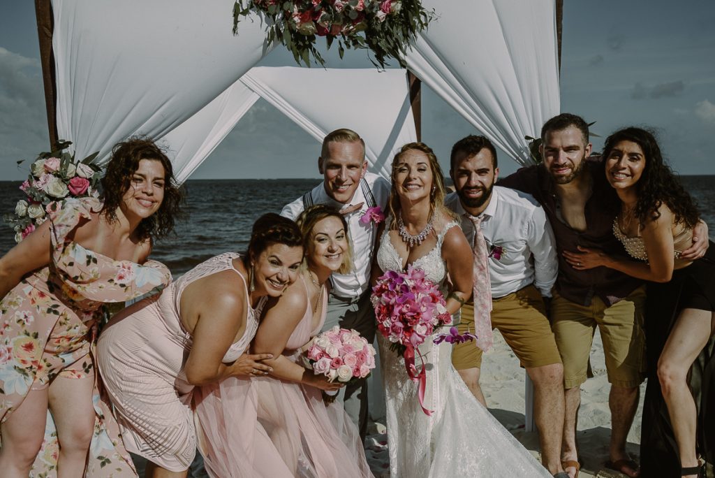 Bride and groom portraits with guests at Now Sapphire Riviera Cancun, Mexico. Caro Navarro Wedding Photography