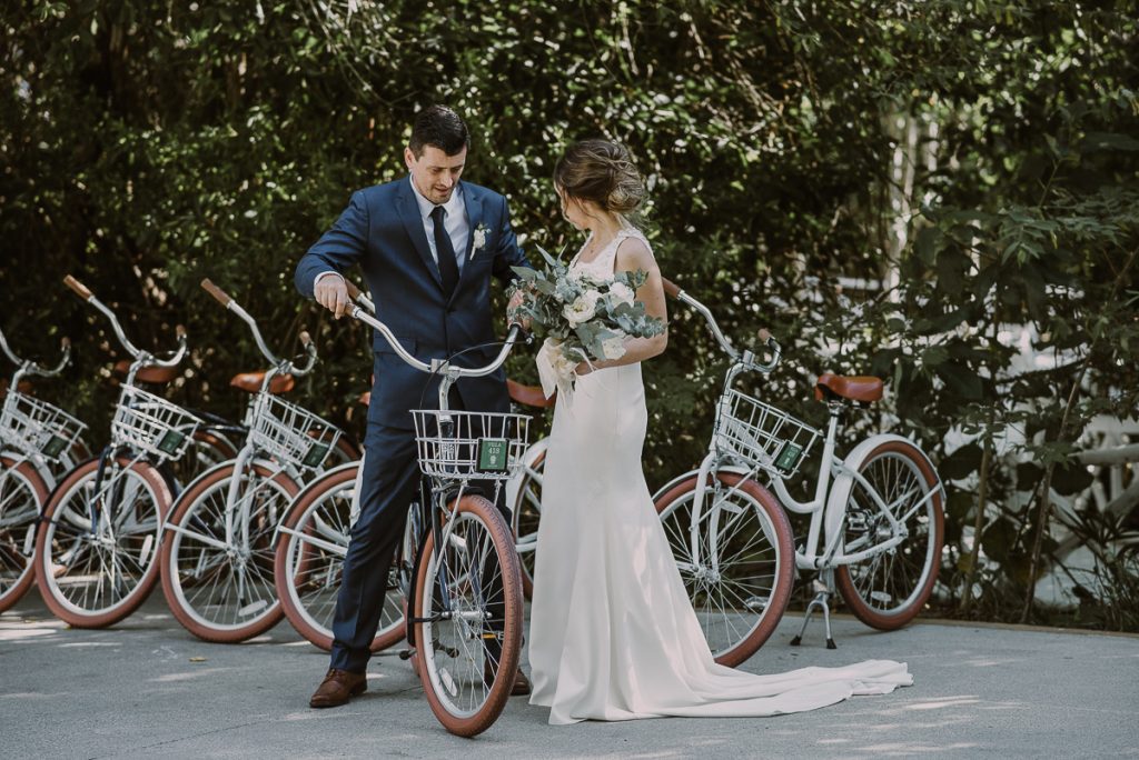 Bride and groom portraits with bikes at Banyan Tree Mayakoba, Mexico by Caro Navarro Photography