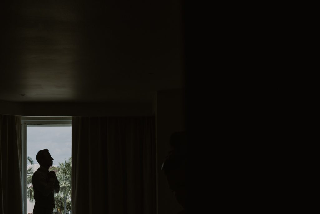 Groom silhouette in room at Moon Palace Nizuc Cancun. Caro Navarro Photography