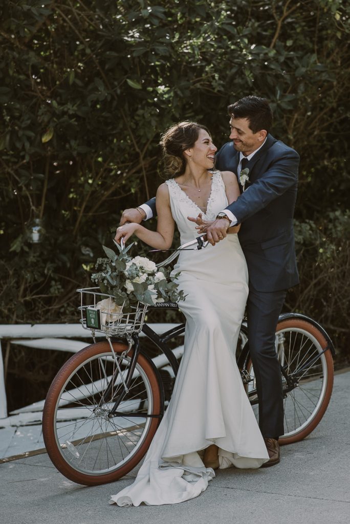 Bride and groom bike portraits at Banyan Tree Mayakoba, Mexico by Caro Navarro Photography