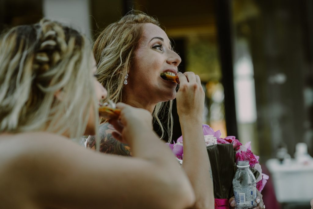 Bride eating a snack at Now Sapphire Riviera Cancun Wedding reception. Caro Navarro Photography