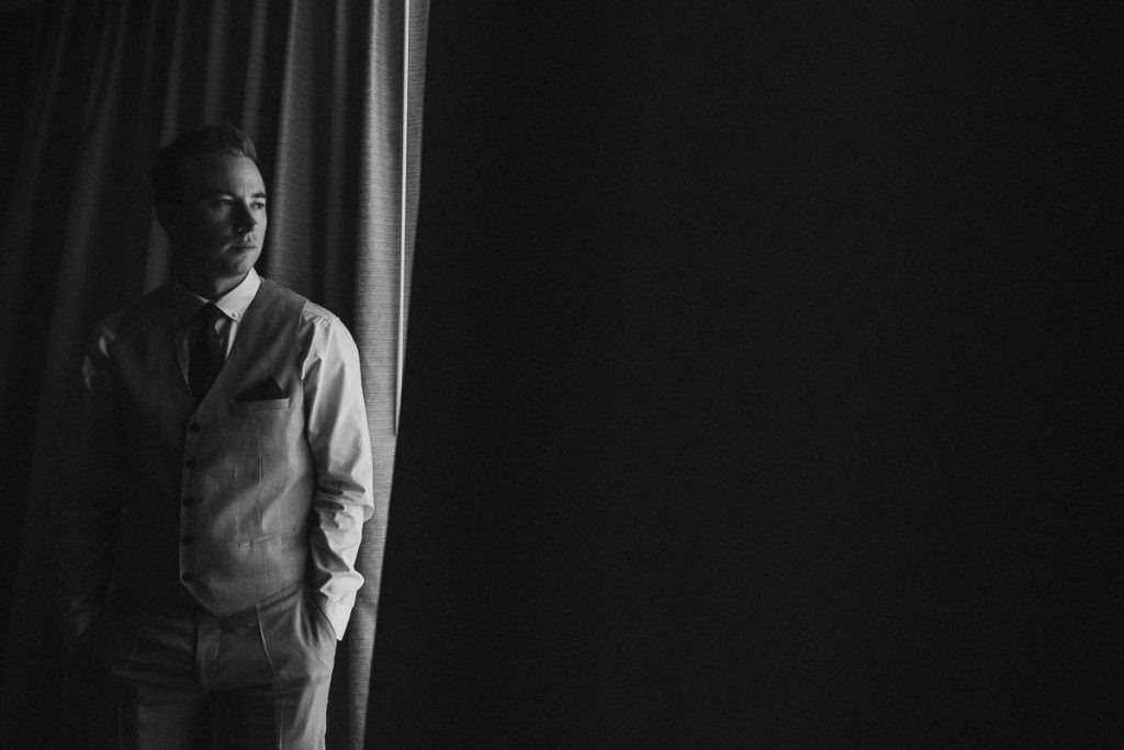 Black and white groom portrait in natural light. Caro Navarro Moon Palace Wedding Photography