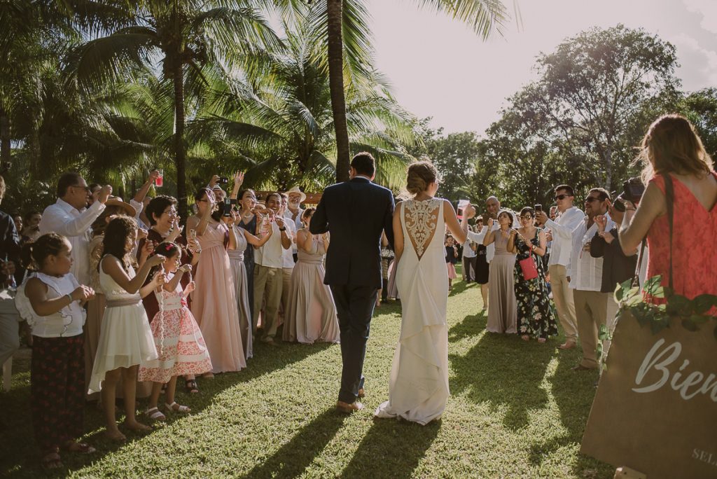 Bride and groom entrance at Playa del Carmen garden wedding by Caro Navarro Photography 