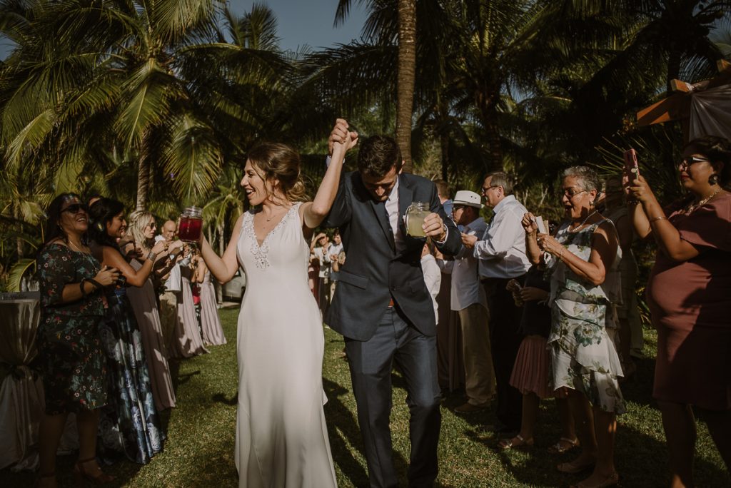 Bride and groom celebrate at Playa del Carmen garden wedding by Caro Navarro Photography