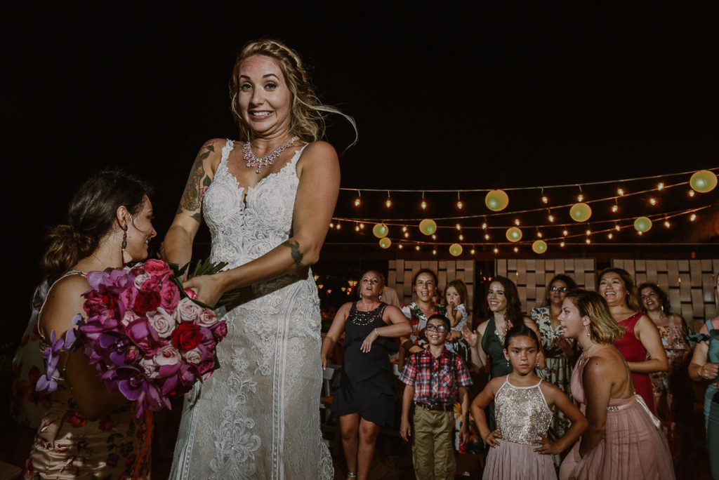 Now Sapphire Riviera Cancun Bouquet toss moment by Caro Navarro Photography
