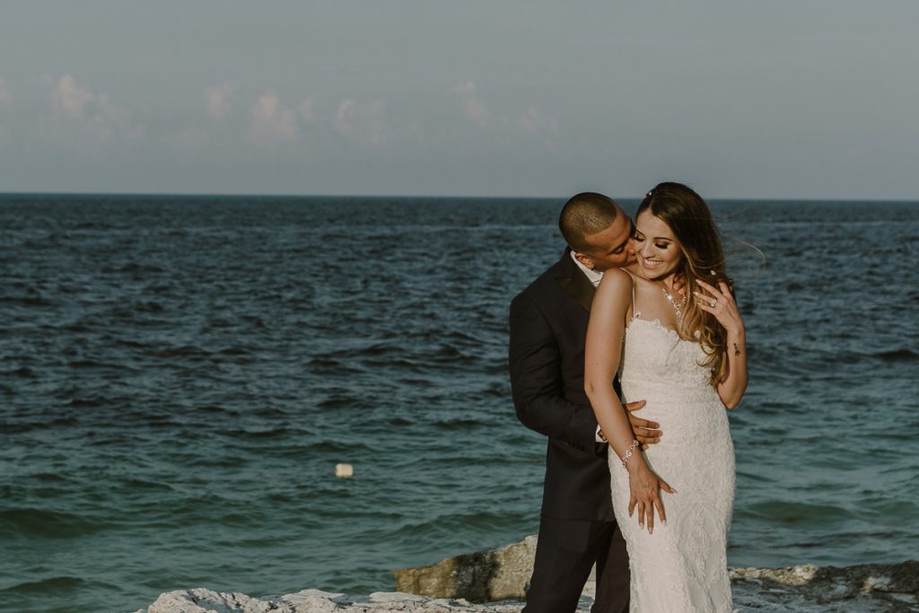 Bride and groom beach portraits. Riu Caribe Cancun destination wedding by Caro Navarro Photography