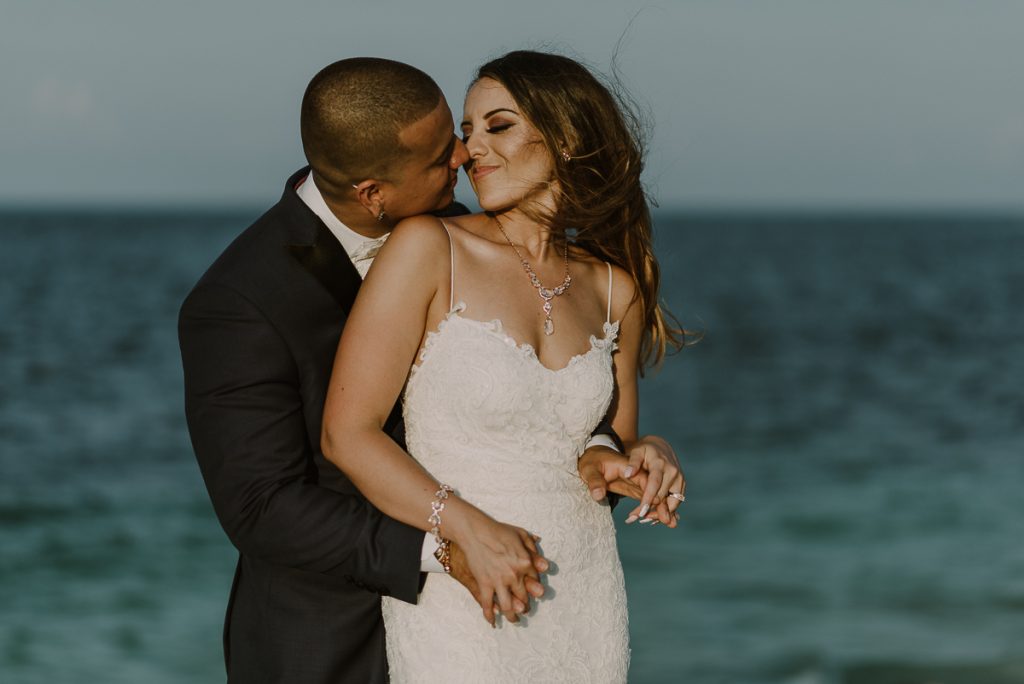 Bride and groom beach portraits. Riu Caribe Cancun destination wedding by Caro Navarro Photography