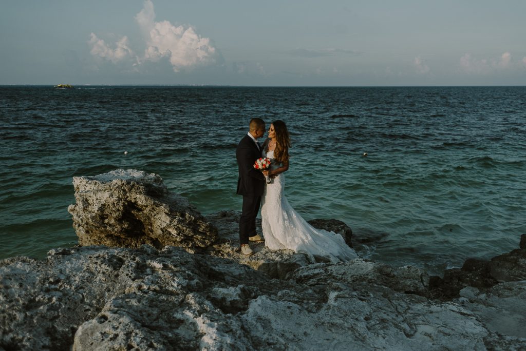Bride and groom cliff portraits. Riu Caribe destination wedding by Caro Navarro Photography