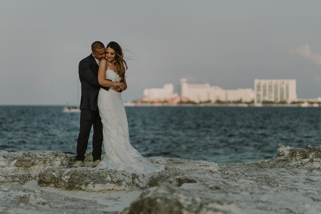 Bride and groom beach portraits. Riu Caribe Cancun destination wedding by Caro Navarro Photography