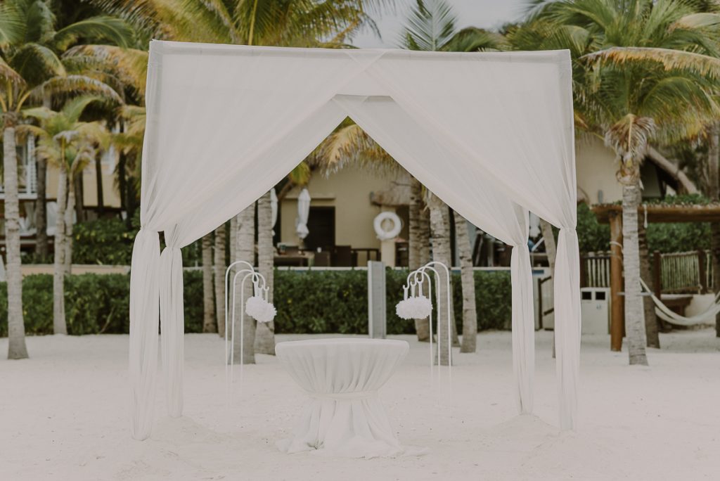 White chuppah at Royal Hideaway Playacar beach elopement in Mexico by Caro Navarro Photography