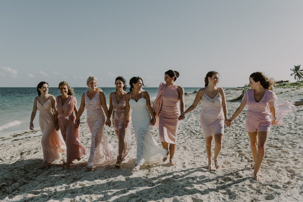 Pink bridesmaids and beach bride at Royalton Riviera Cancun. Caro Navarro Photography 