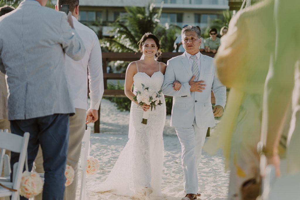 Emotional bride entrance. Royalton Riviera Cancun beach wedding by Caro Navarro Photography