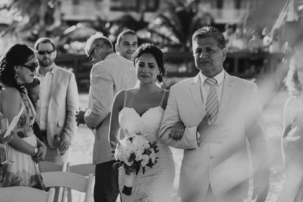 Emotional bride walking down the aisle. Royalton Riviera Cancun wedding by Caro Navarro Photography