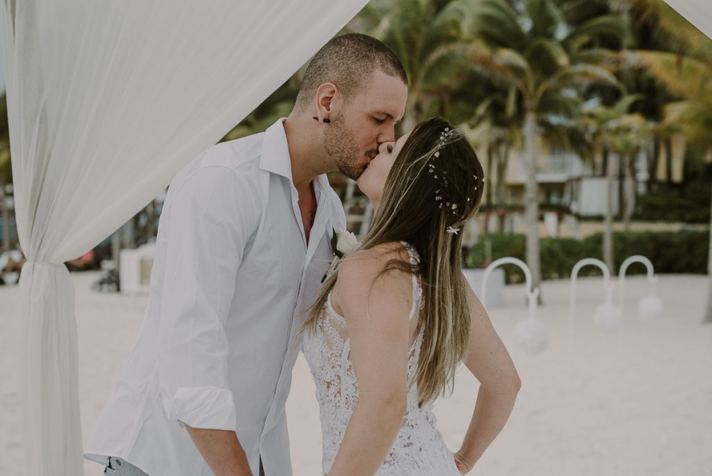 You may kiss the bride. Royal Hideaway Playacar beach elopement in Mexico by Caro Navarro Photography