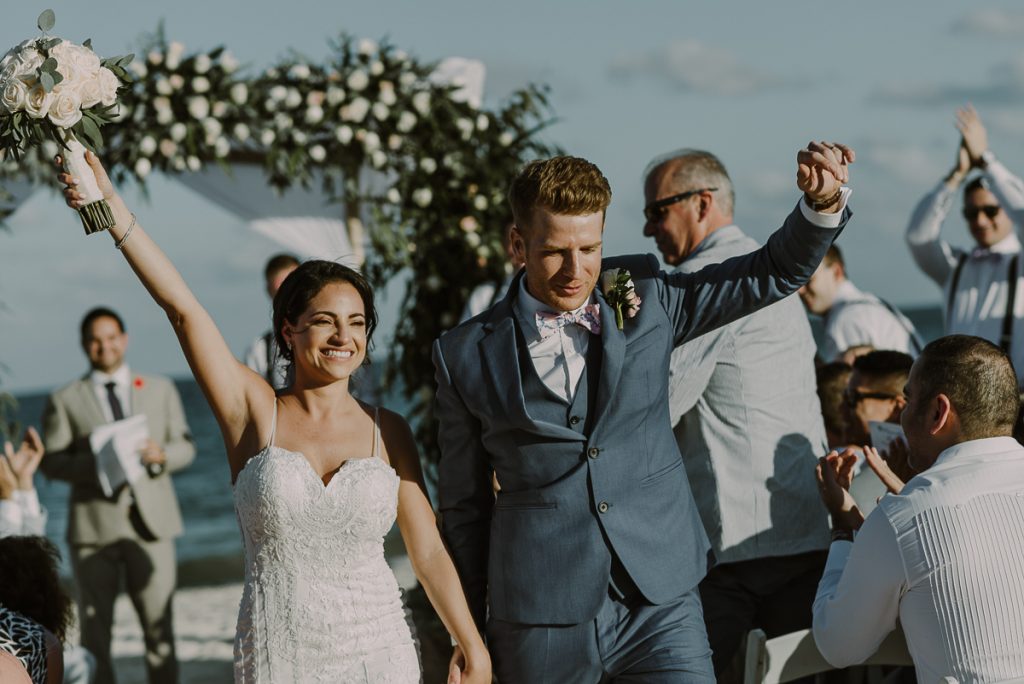 Newlyweds exit. Royalton Riviera Cancun destination wedding by Caro Navarro Photography