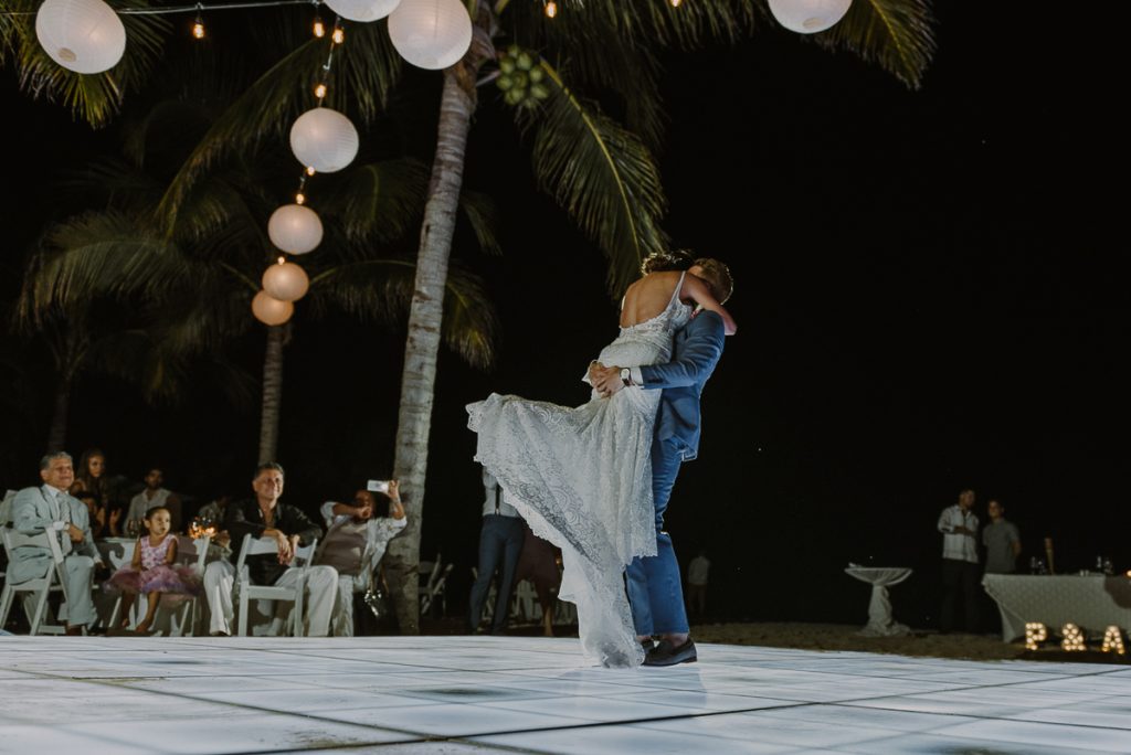 Bride and groom first dance under bistro lights. Royalton Riviera Cancun reception. Caro Navarro Photography