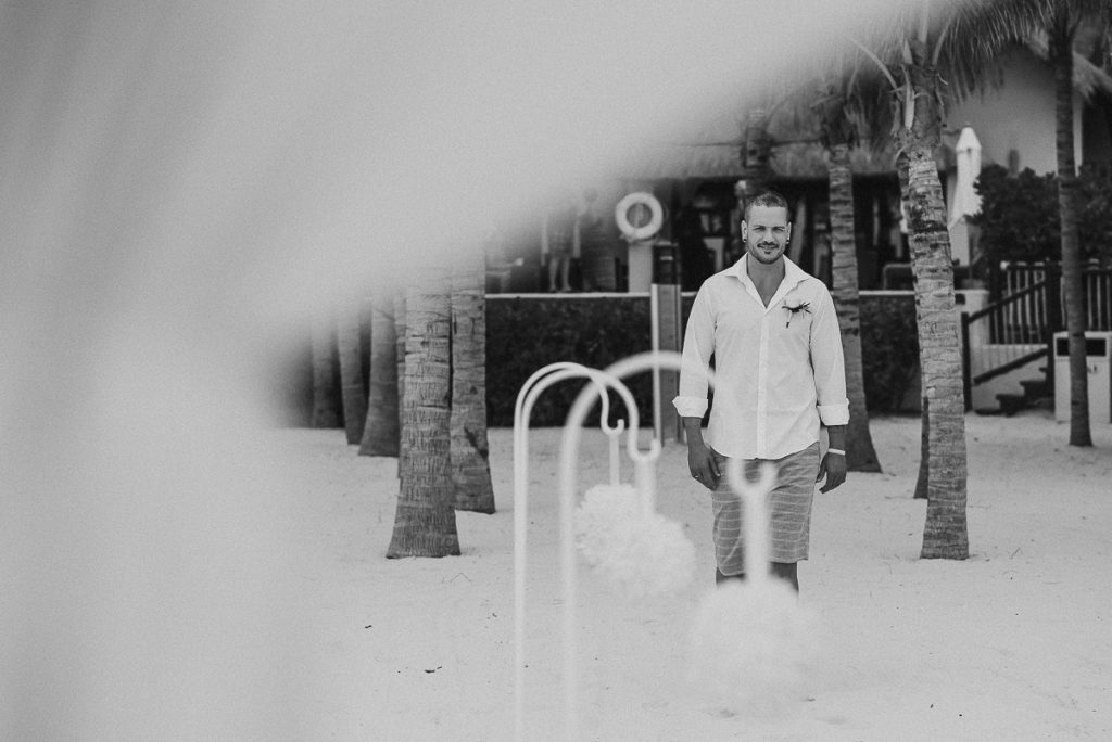 Groom walking down the aisle at Royal Hideaway Playacar beach elopement in Mexico by Caro Navarro Photography