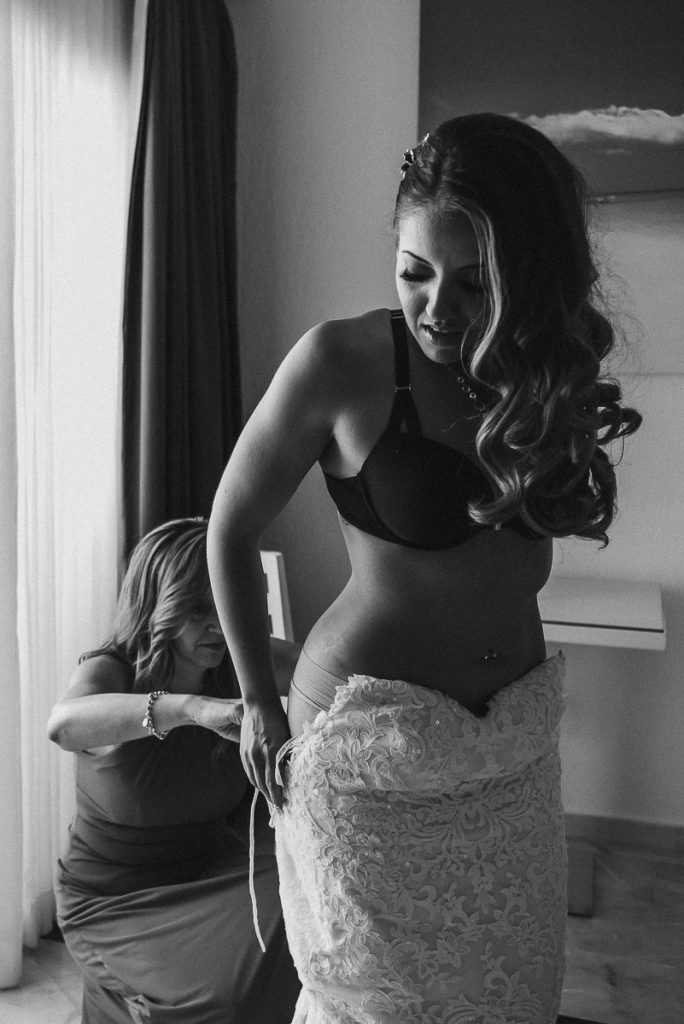 Destination bride getting into her wedding dress. Riu Caribe Cancun, Caro Navarro Photography