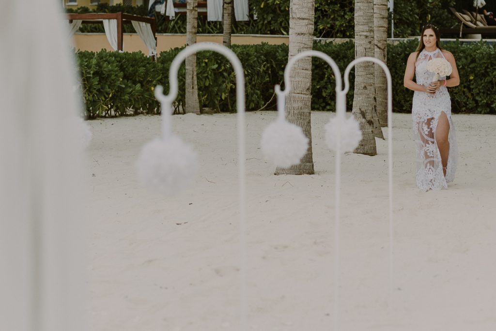 Bride walking the aisle at Royal Hideaway Playacar beach elopement in Mexico by Caro Navarro Photography