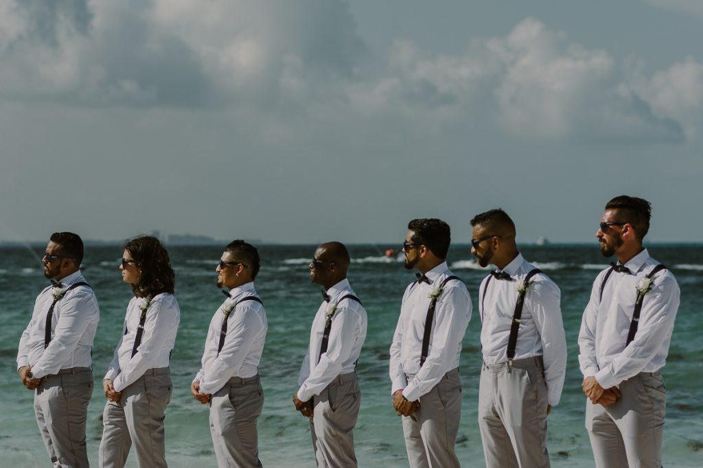Groomsmen at Riu Caribe Cancun beach wedding by Caro Navarro Photography