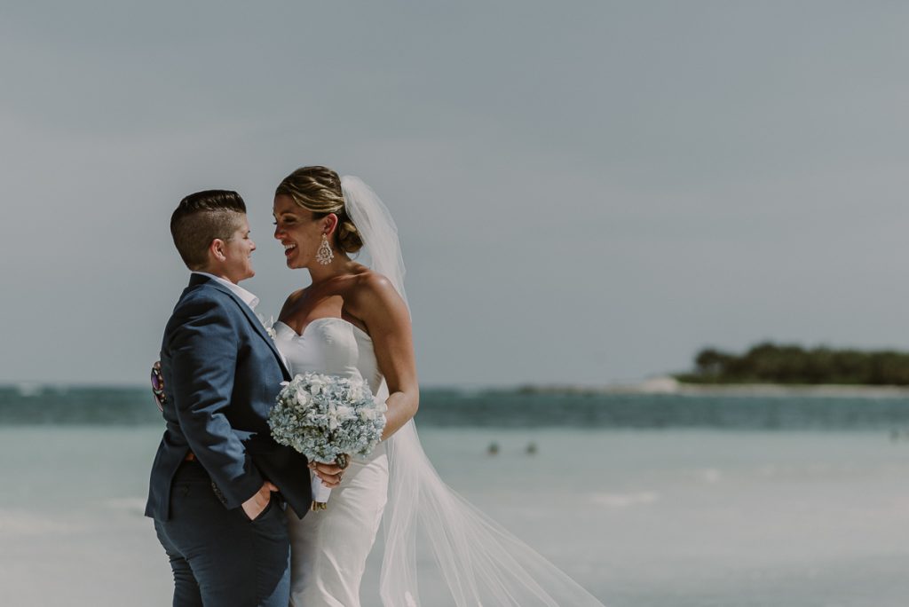 Bride and bride beach portraits at Grand Palladium Riviera Maya LGBT Wedding in Mexico. Caro Navarro Photography