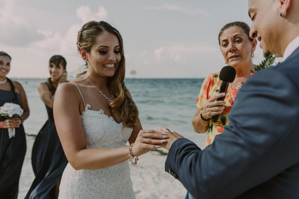 Ring exchange at Riu Caribe Cancun beach wedding by Caro Navarro Photography