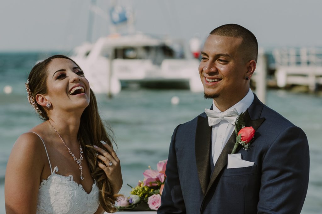 Happy bride and groom at Riu Caribe Cancun beach wedding by Caro Navarro Photography
