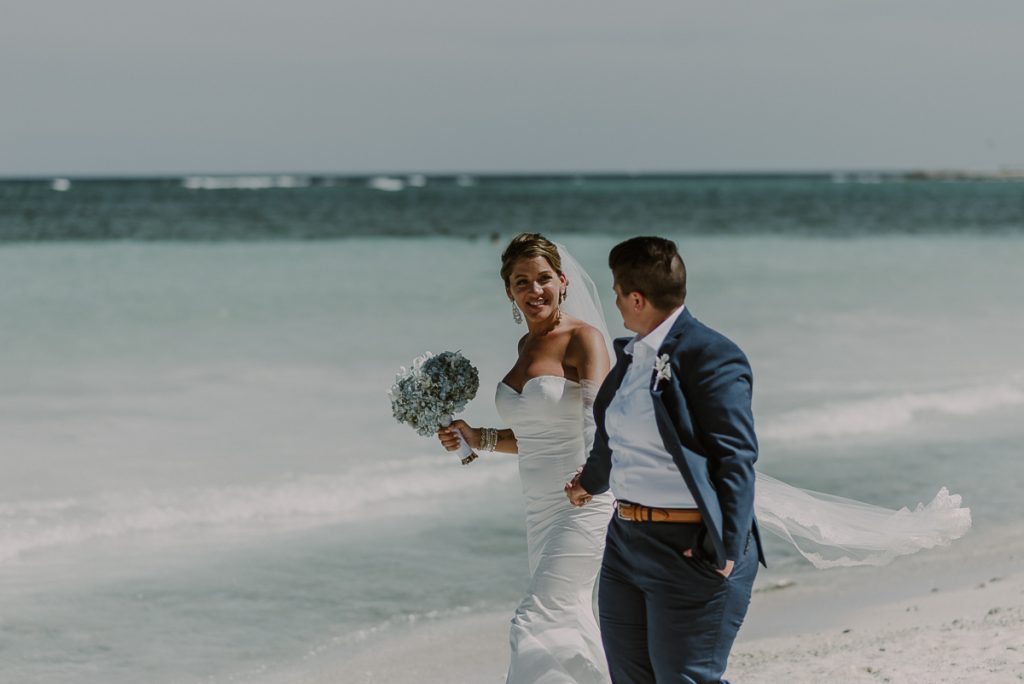 Bride and bride beach portraits at Grand Palladium Riviera Maya LGBT Wedding in Mexico. Caro Navarro Photography