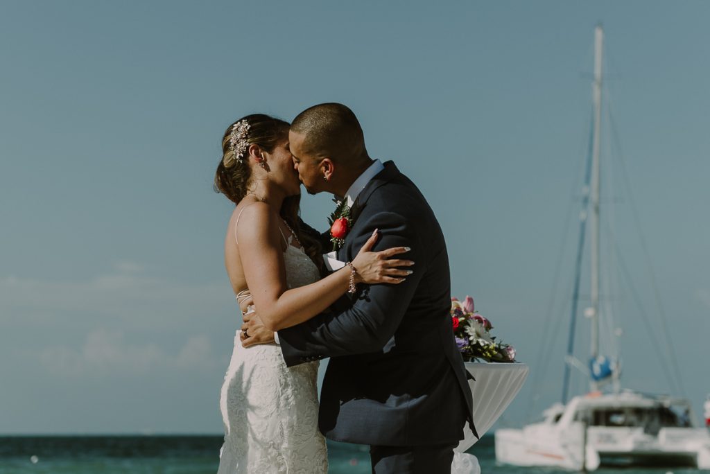 You may kiss the bride. Riu Caribe Cancun beach destination wedding by Caro Navarro Photography
