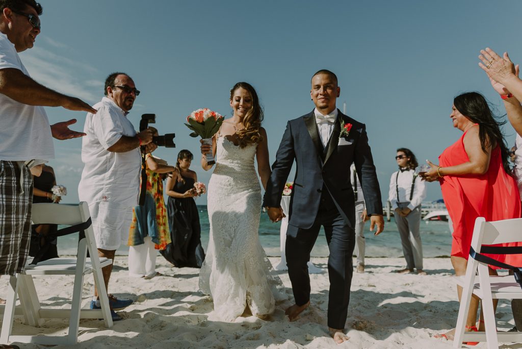 Bride and groom exit, Riu Caribe Cancun beach destination wedding by Caro Navarro Photography