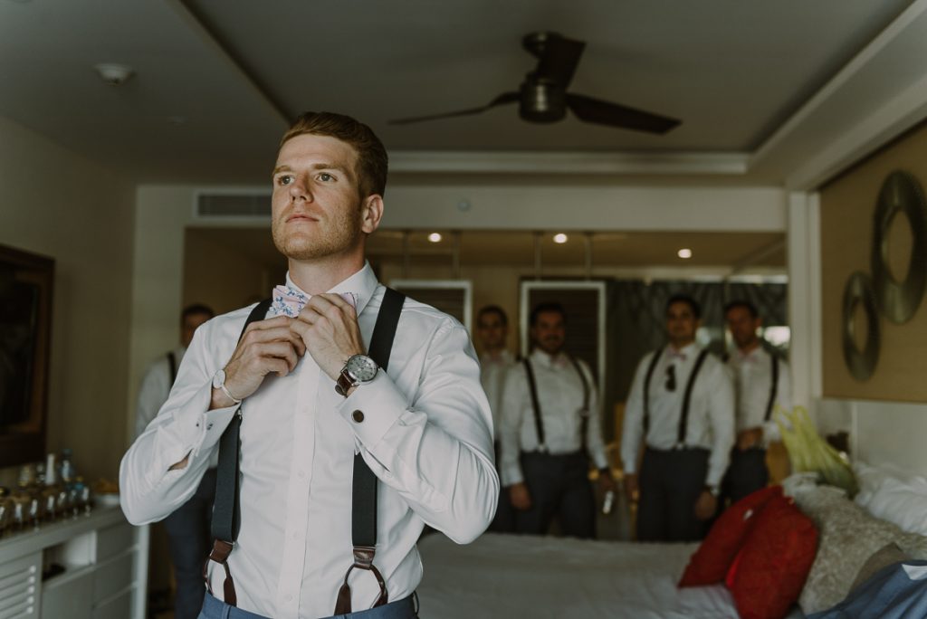 Groom getting ready with groomsmen. Royalton Riviera Cancun Wedding by Caro Navarro Photography