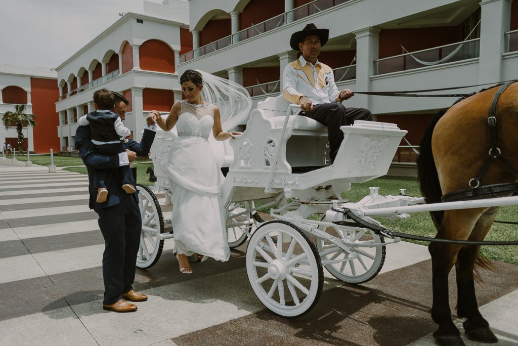 Bride steps of white carriage at Hard Rock Riviera Maya Destination Wedding. Caro Navarro Photography