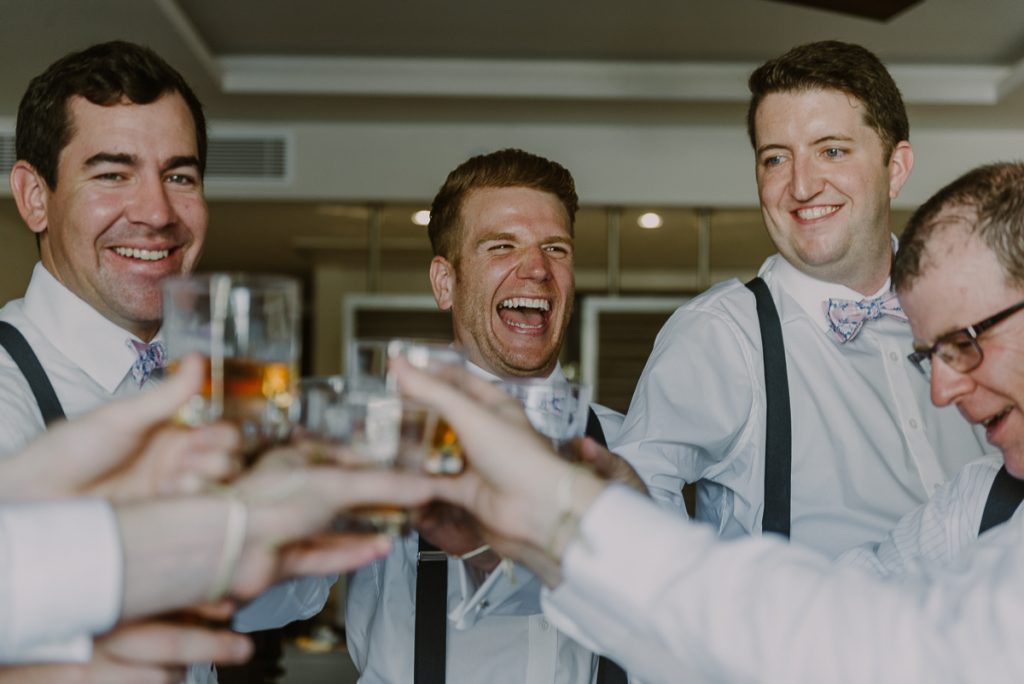 Groom and groomsmen pre-wedding toast at Royalton Riviera Cancun, Mexico. Caro Navarro Photography