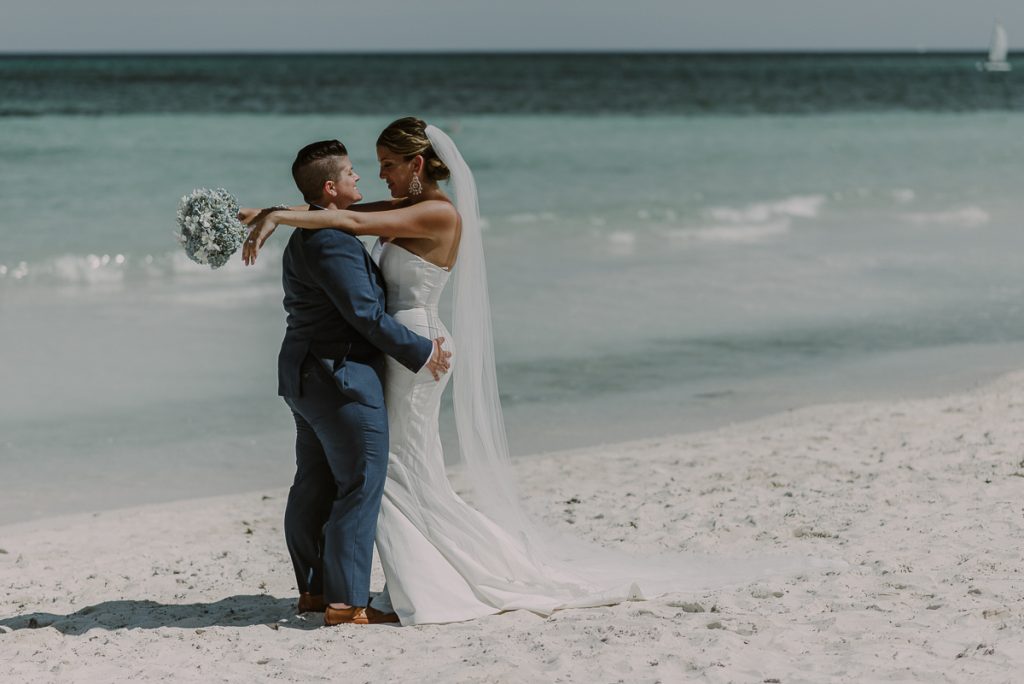Bride and bride beach portraits at Grand Palladium Riviera Maya LGBT Wedding in Mexico. Caro Navarro Photography