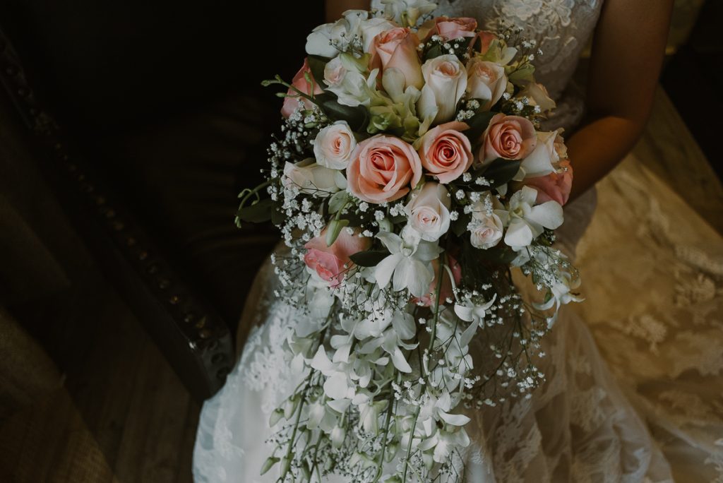 Roses and orchids cascade bouquet at Glam Hard Rock Riviera Maya Destination Wedding. Caro Navarro Photography