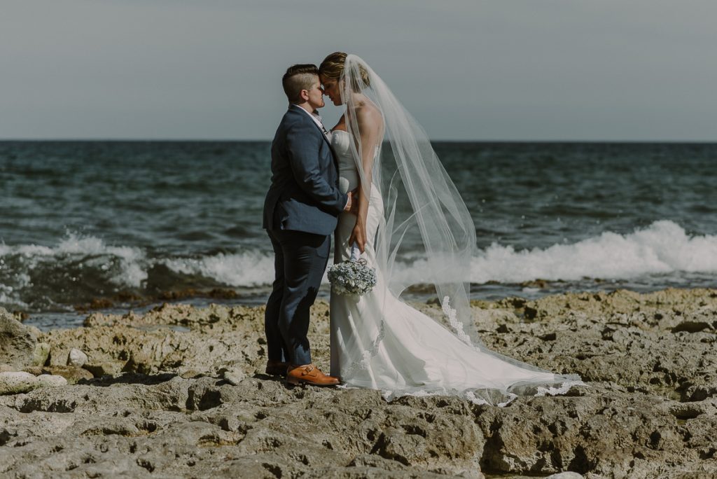 Bride and bride beach portraits at Grand Palladium Riviera Maya LGBT Wedding in Mexico. Caro Navarro Photography
