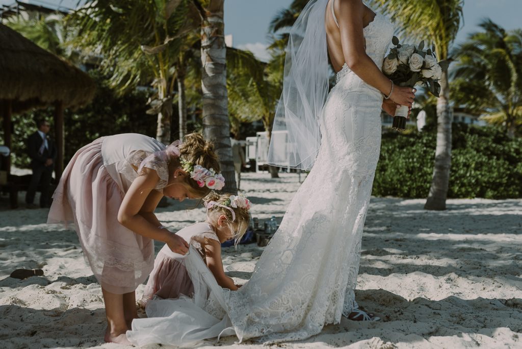 Flower girls helping bride. Royalton Riviera Cancun Beach Wedding by Caro Navarro Photography